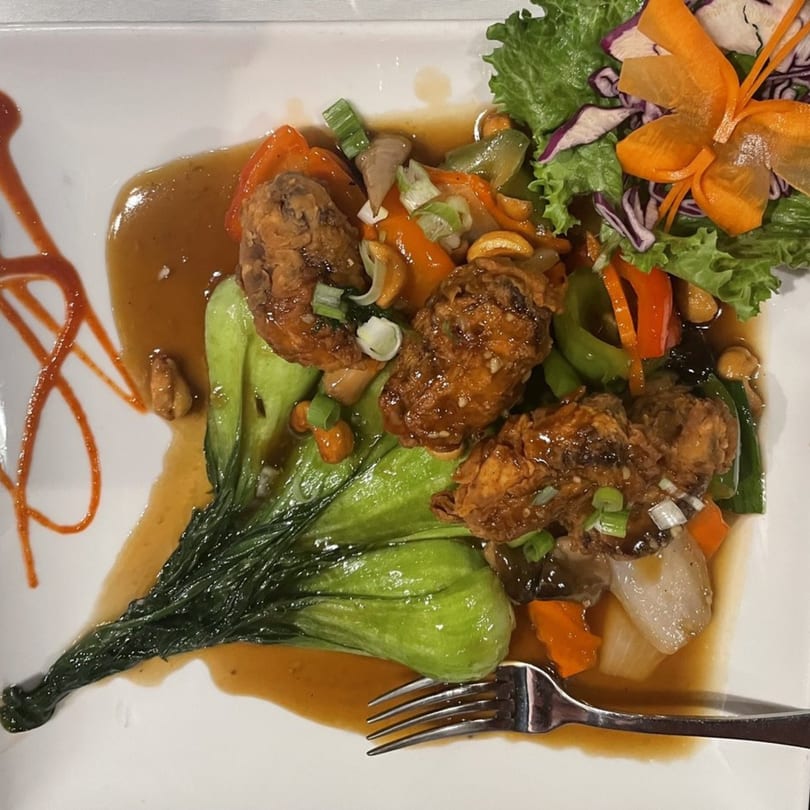 Jutamas Thai Restaurant's crispy duck with bok choy, bell peppers, cashews, and brown sauce.